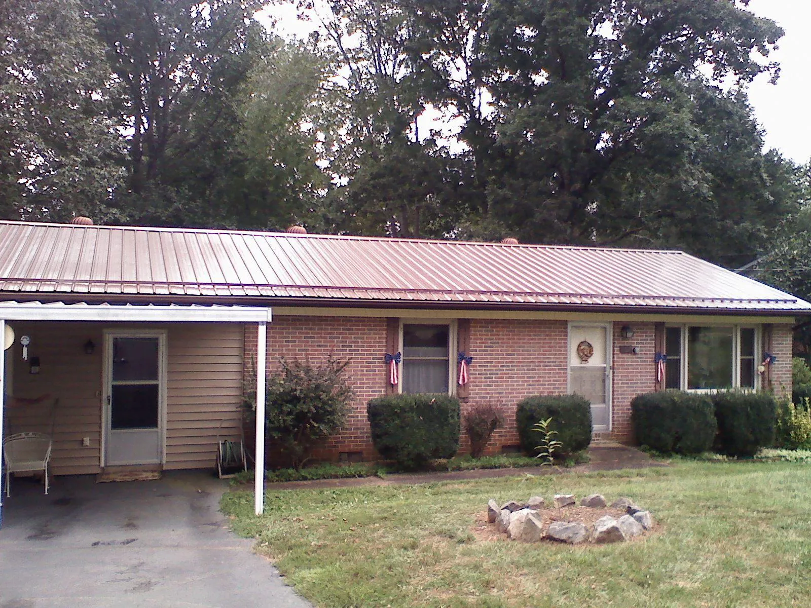 Bronze metal roof and carport on a brick ranch home — Roof Repair work by our crew in Silverlake